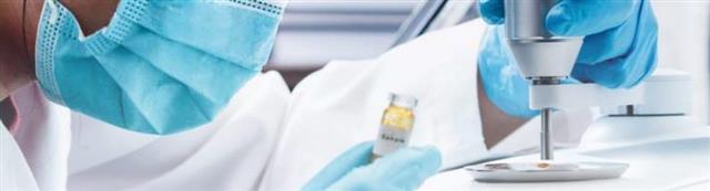 Scientist preparing a sample at an FTIR microscope