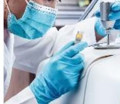Technician placing a sample vial in a GC autosampler