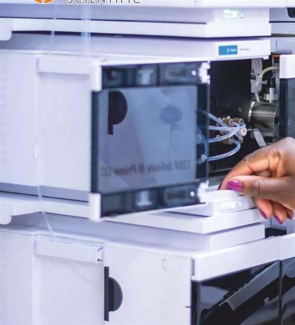 Lab technician servicing an HPLC instrument stack