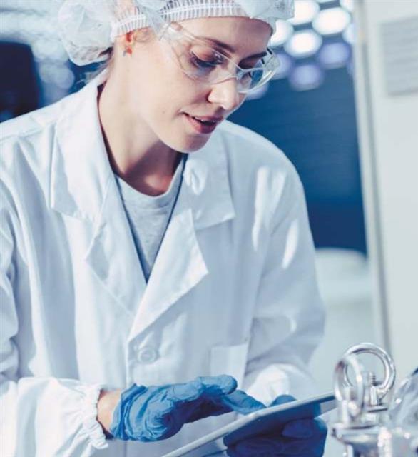 Scientist recording cleaning validation results on a tablet