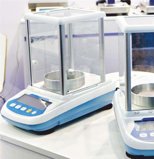 Analytical balances with draft shields on a lab bench